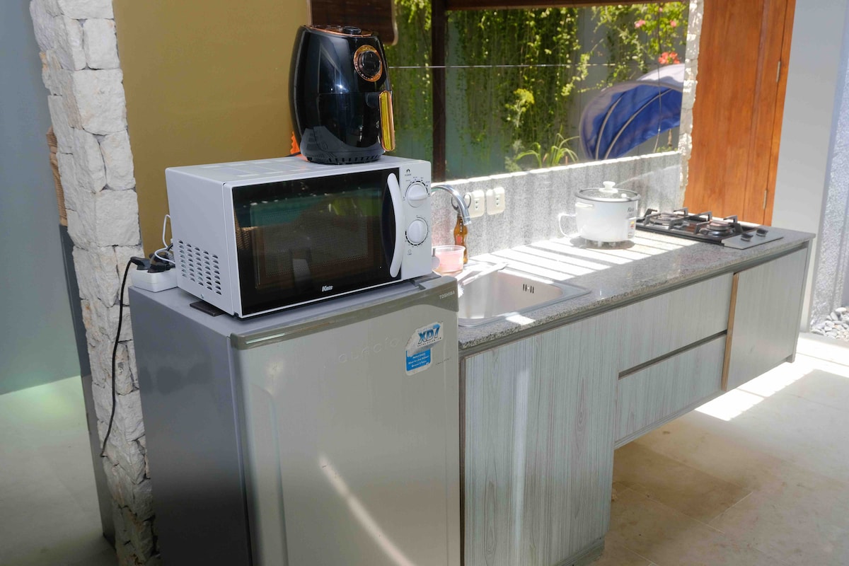 The kitchen itself is equipped with stove, fridge, microwave, air fryer. Also available on request: rice cooker. Inside the drawers there are tableware, cutleries & utensils. Below the sink there are hygiene kits provided in needs.